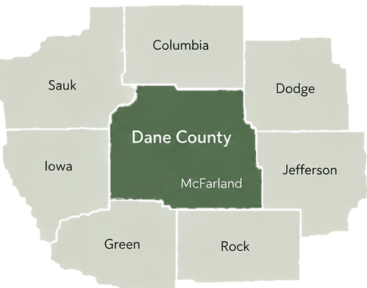 Map of Dane County and the counties that border it — Sauk, Columbia, Dodge, Jefferson, Rock, Green, and Iowa — with Dane County highlighted at the center and Nikki's home office marked in McFarland.